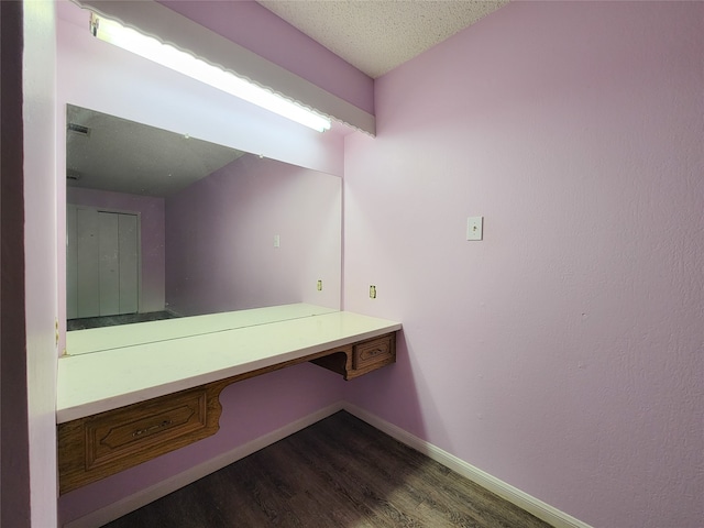 bathroom with a textured ceiling and hardwood / wood-style floors