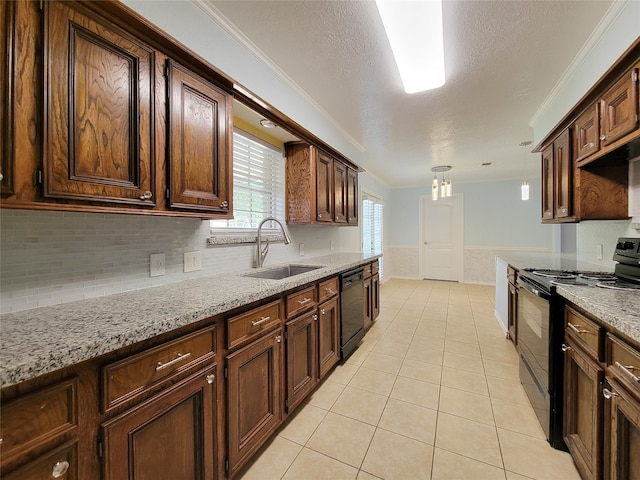 kitchen with light stone countertops, a textured ceiling, black appliances, ornamental molding, and sink