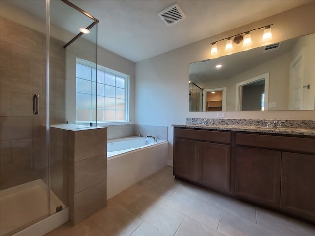 bathroom featuring tile patterned flooring, vanity, and plus walk in shower