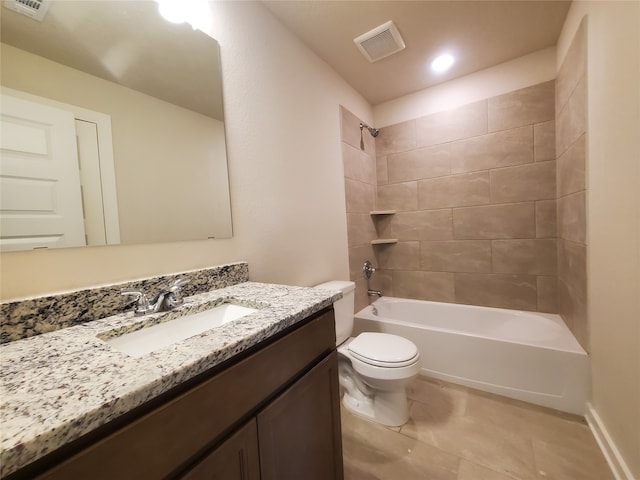 full bathroom featuring tiled shower / bath combo, toilet, and vanity