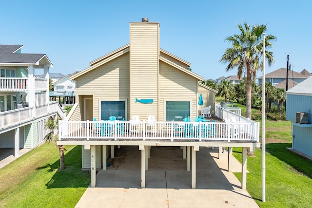 back of house with a lawn and a deck