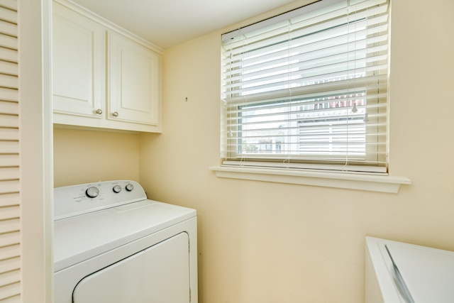 laundry room with washer / clothes dryer and cabinets