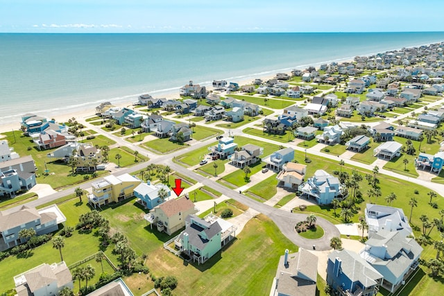 birds eye view of property with a view of the beach and a water view