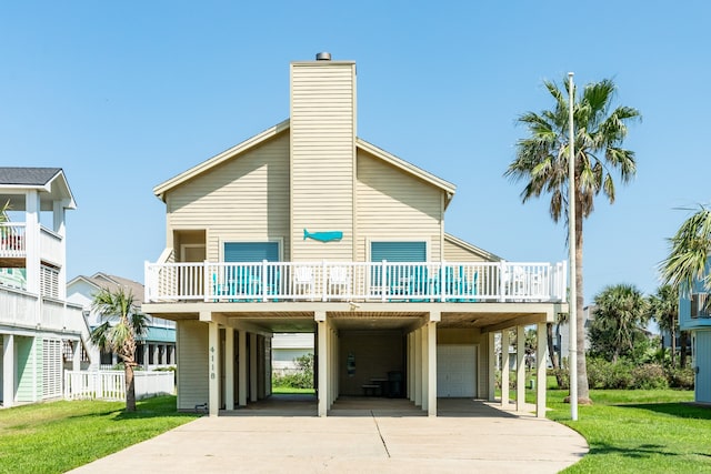 rear view of property featuring a carport and a yard