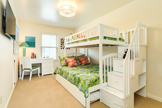 bedroom featuring light carpet