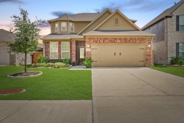 view of front of house featuring a lawn and a garage