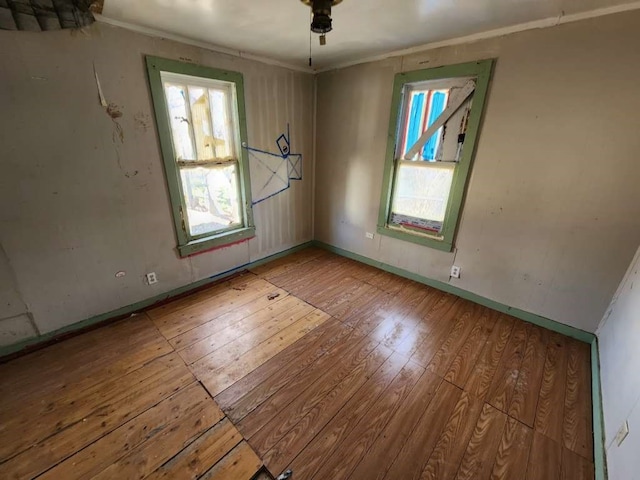 empty room with light wood-type flooring and ceiling fan