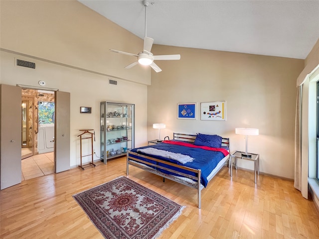 bedroom featuring ceiling fan, wood-type flooring, and lofted ceiling