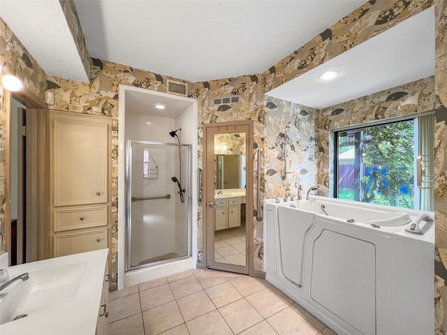 bathroom featuring tile patterned flooring, vanity, and shower with separate bathtub