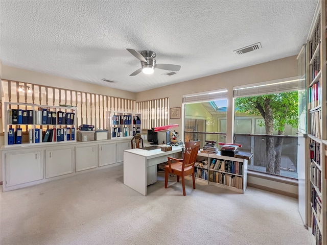 office space with ceiling fan and a textured ceiling