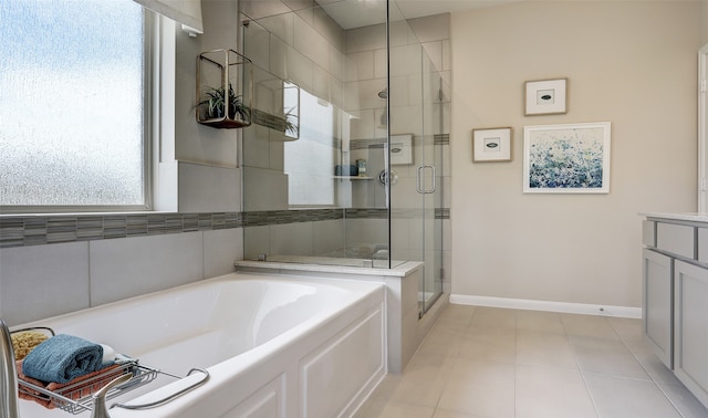 bathroom with tile patterned floors, vanity, and shower with separate bathtub