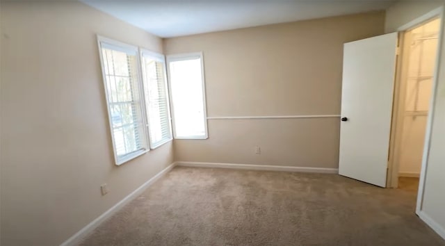 unfurnished room with light colored carpet