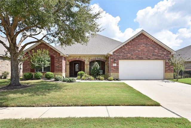 view of front of house with a front lawn and a garage