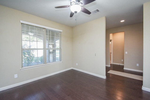 spare room featuring dark hardwood / wood-style floors and ceiling fan