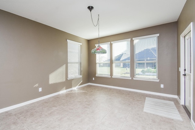 unfurnished dining area featuring light tile patterned flooring