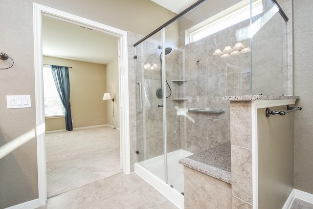 bathroom featuring an enclosed shower and tile patterned flooring