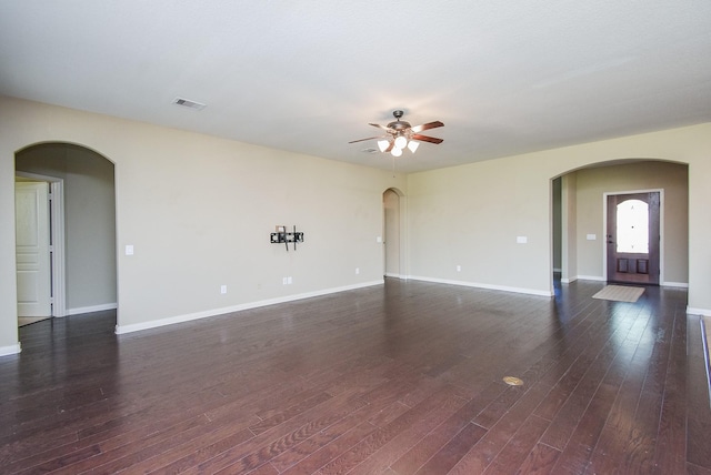 spare room featuring dark wood-type flooring and ceiling fan