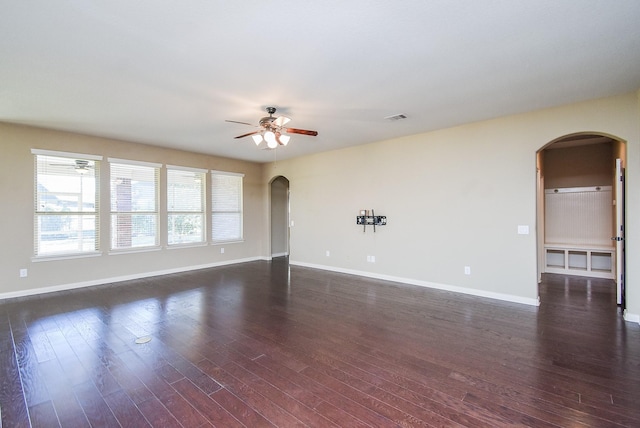 spare room with ceiling fan and dark hardwood / wood-style floors