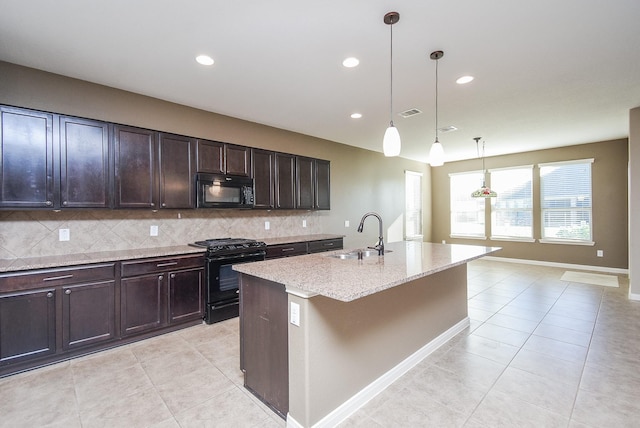 kitchen featuring black appliances, a kitchen island with sink, decorative backsplash, sink, and pendant lighting