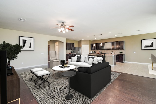 living room featuring light hardwood / wood-style floors and ceiling fan