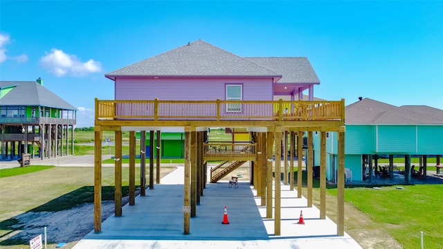 exterior space with a carport, a deck, and a yard