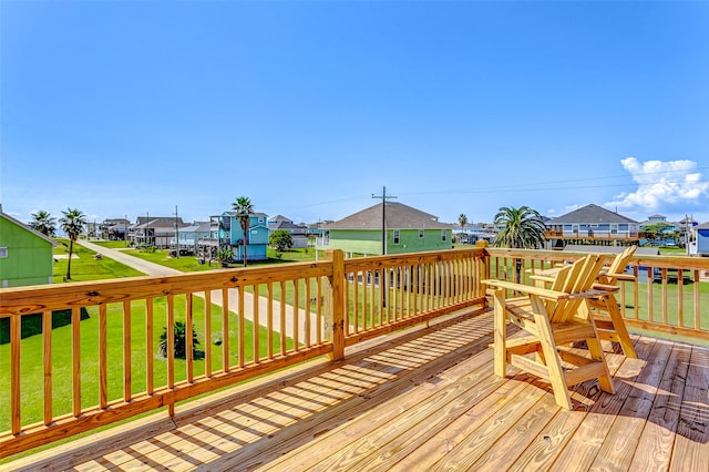 wooden deck featuring a yard