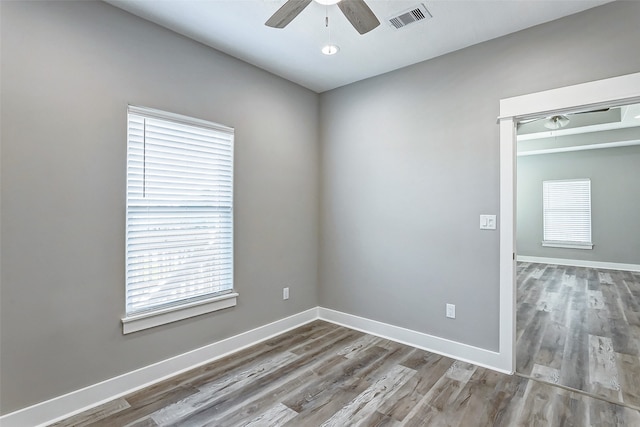 empty room with ceiling fan and hardwood / wood-style flooring