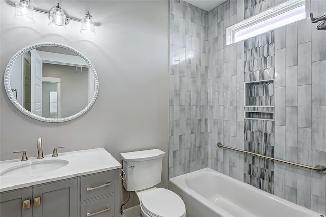 full bathroom with vanity, tiled shower / bath combo, and toilet