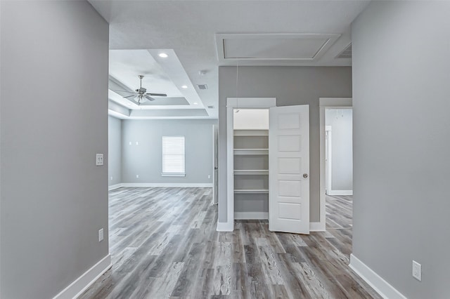 interior space featuring light wood-type flooring and a raised ceiling