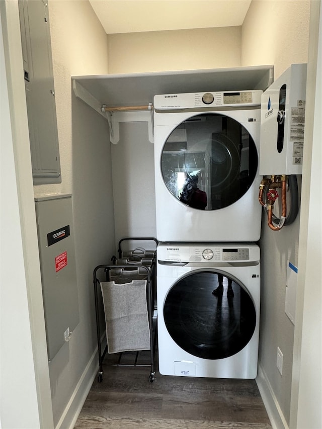 clothes washing area featuring electric panel, dark hardwood / wood-style floors, and stacked washing maching and dryer