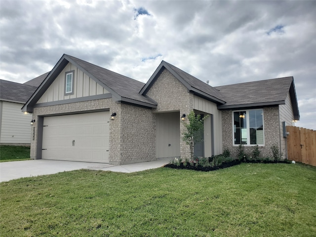 view of front of house featuring a garage and a front lawn