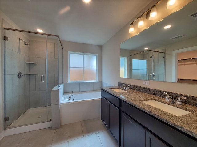 bathroom with plus walk in shower, vanity, and tile patterned floors