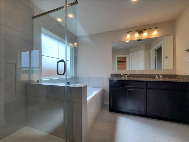 bathroom with plus walk in shower, vanity, and tile patterned floors