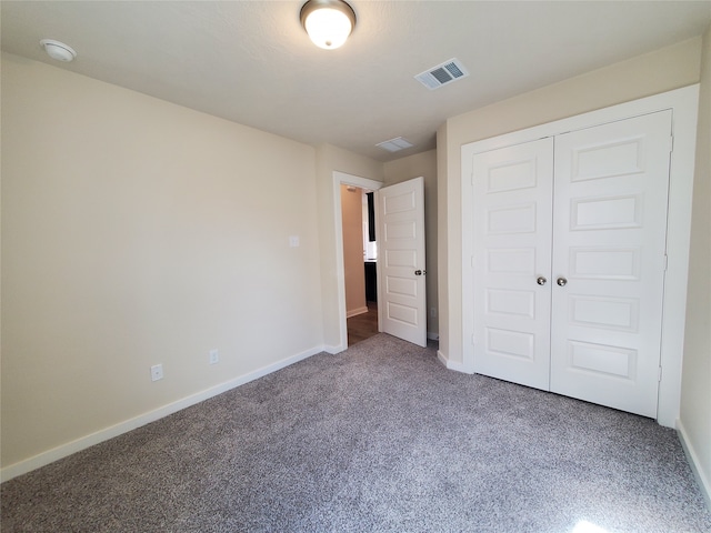 unfurnished bedroom featuring a closet and carpet