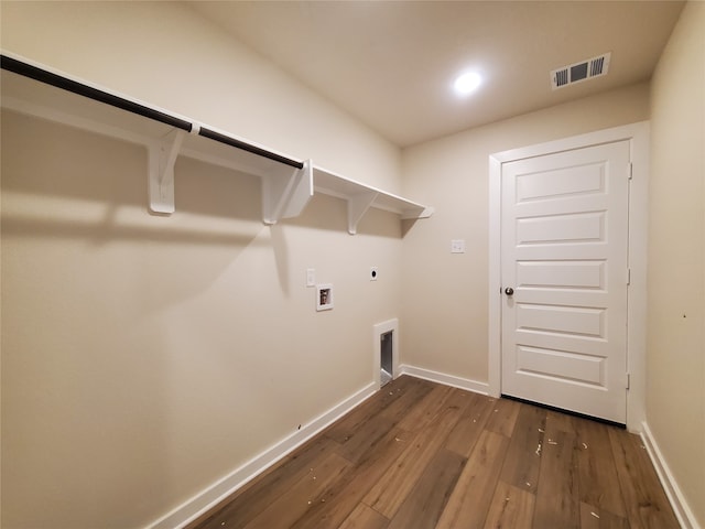 clothes washing area with electric dryer hookup, hookup for a washing machine, and dark hardwood / wood-style floors