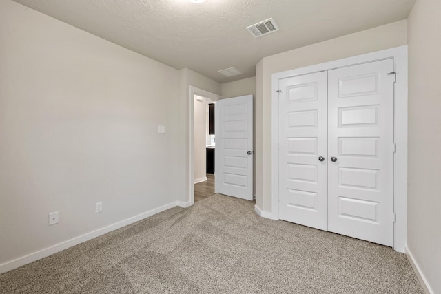 1409 Whitney Ln, Brenham, TX 77833 - unfurnished bedroom with a closet, visible vents, baseboards, and light carpet