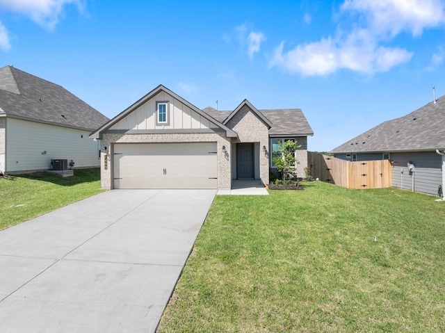 1409 Whitney Ln, Brenham, TX 77833 - view of front of house featuring concrete driveway, a front lawn, board and batten siding, cooling unit, and a garage