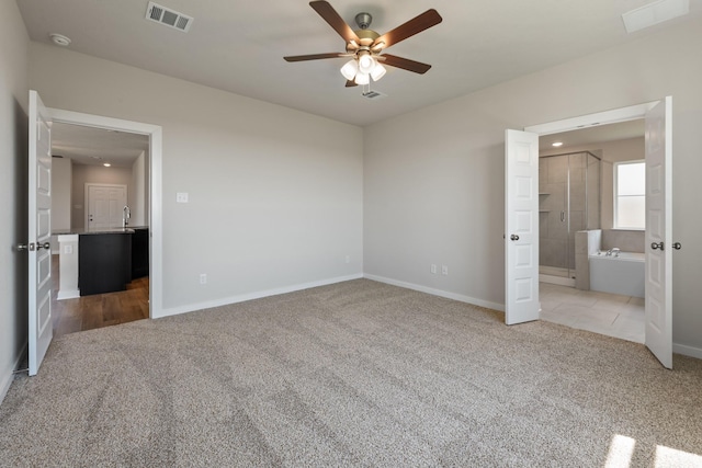 1409 Whitney Ln, Brenham, TX 77833 - unfurnished bedroom featuring baseboards, visible vents, and carpet floors
