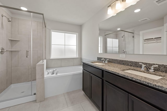 1409 Whitney Ln, Brenham, TX 77833 - bathroom with a shower stall, visible vents, a garden tub, and a sink
