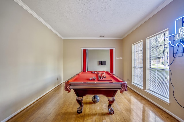 playroom with a textured ceiling, light hardwood / wood-style flooring, ornamental molding, and pool table