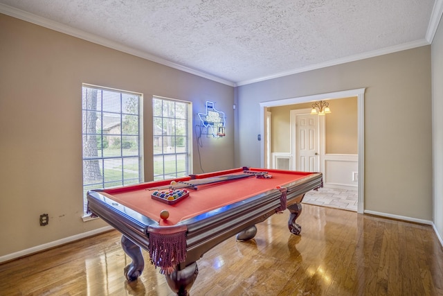 playroom featuring ornamental molding, a textured ceiling, pool table, and light hardwood / wood-style flooring