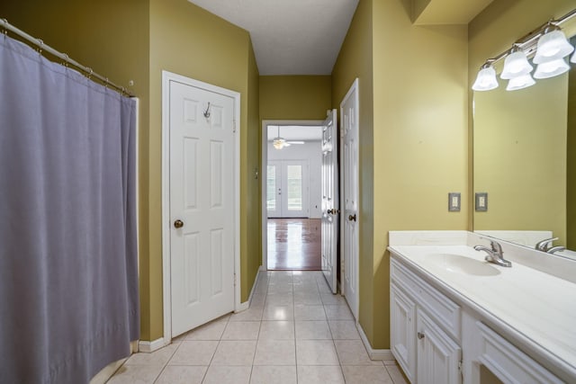 bathroom with tile patterned floors, vanity, and ceiling fan