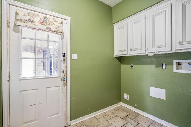 laundry room featuring electric dryer hookup, hookup for a washing machine, and cabinets