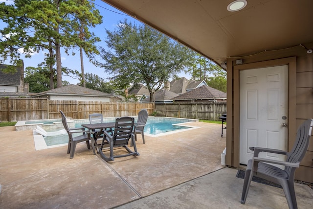 view of pool with a jacuzzi and a patio