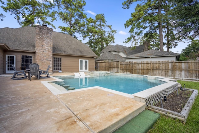 view of swimming pool with a patio area and french doors