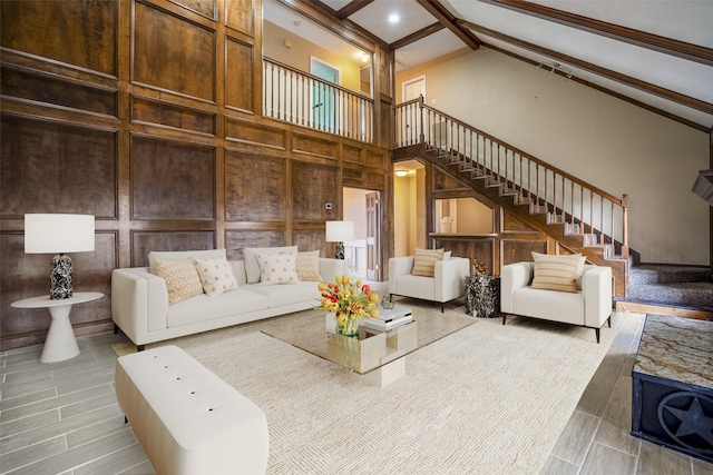 living room featuring beam ceiling, hardwood / wood-style floors, and high vaulted ceiling