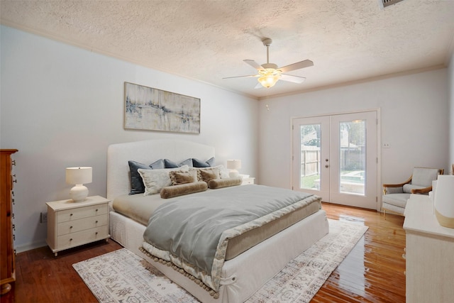 bedroom with french doors, access to outside, ceiling fan, and dark wood-type flooring