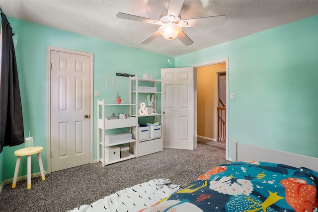 bedroom featuring carpet, ceiling fan, and a textured ceiling