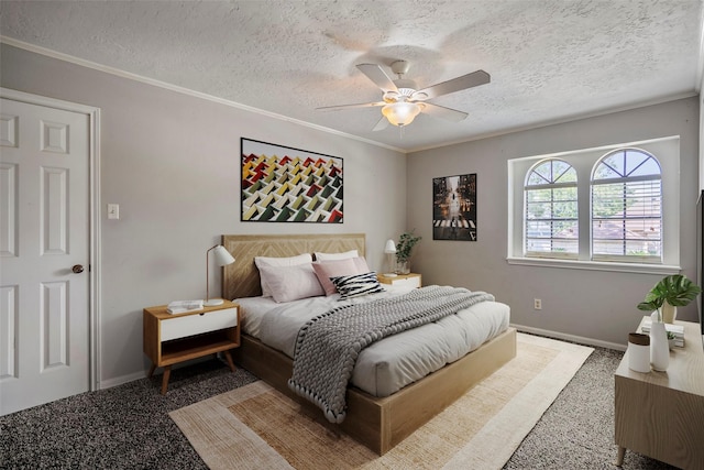 carpeted bedroom with a textured ceiling, ceiling fan, and crown molding