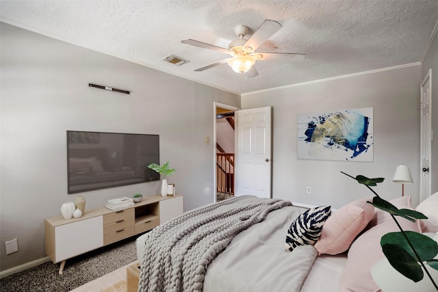 bedroom with a textured ceiling, light colored carpet, ceiling fan, and crown molding